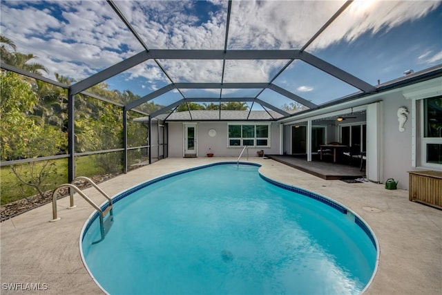 view of pool featuring a lanai, a patio, and ceiling fan