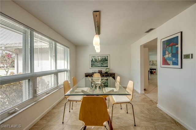 dining room with a healthy amount of sunlight and light tile patterned floors