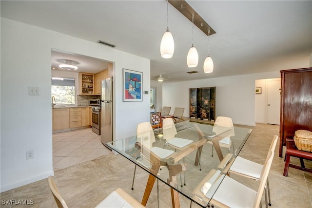 tiled dining room with ceiling fan