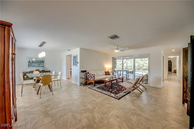 living room featuring ceiling fan with notable chandelier