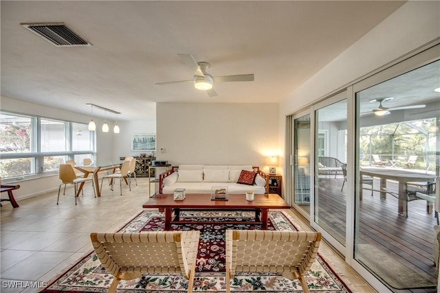 living room featuring light tile patterned flooring and ceiling fan