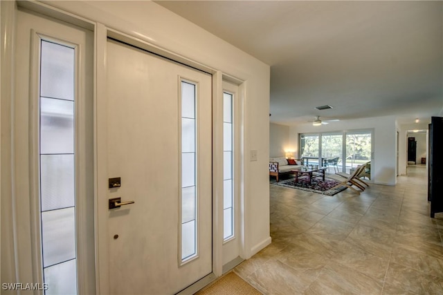 doorway to outside featuring ceiling fan