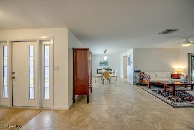 tiled foyer entrance featuring ceiling fan