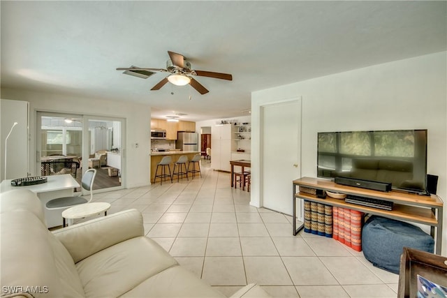 tiled living room with ceiling fan