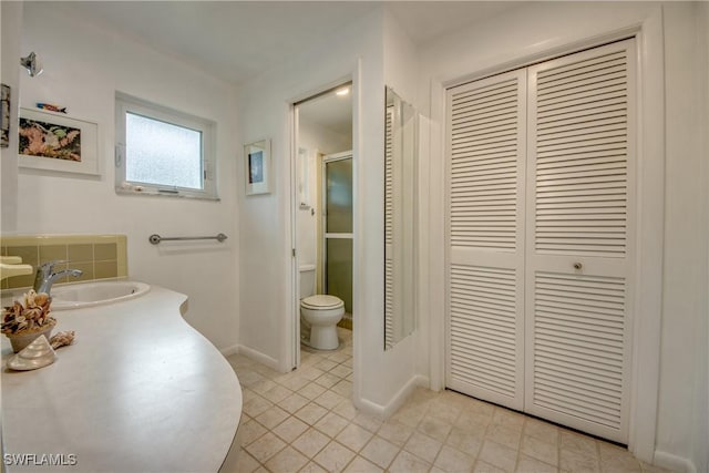 bathroom with tile patterned floors, vanity, and toilet