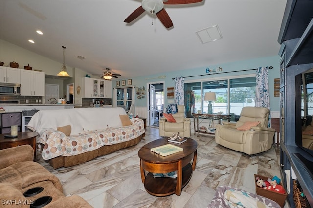 living room featuring ceiling fan and vaulted ceiling