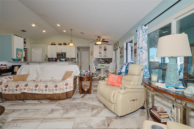 living room with ceiling fan and lofted ceiling