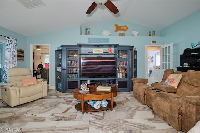 living room featuring ceiling fan and lofted ceiling