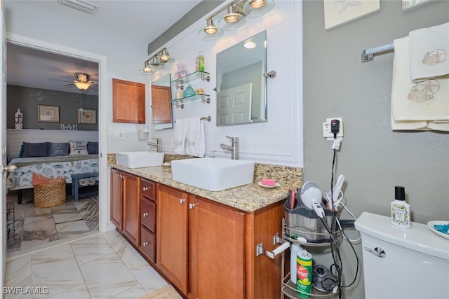 bathroom featuring ceiling fan, vanity, and toilet