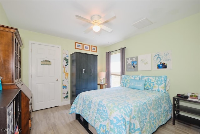 bedroom with ceiling fan and light hardwood / wood-style flooring