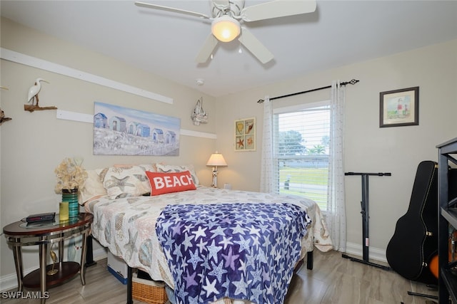 bedroom with wood-type flooring and ceiling fan