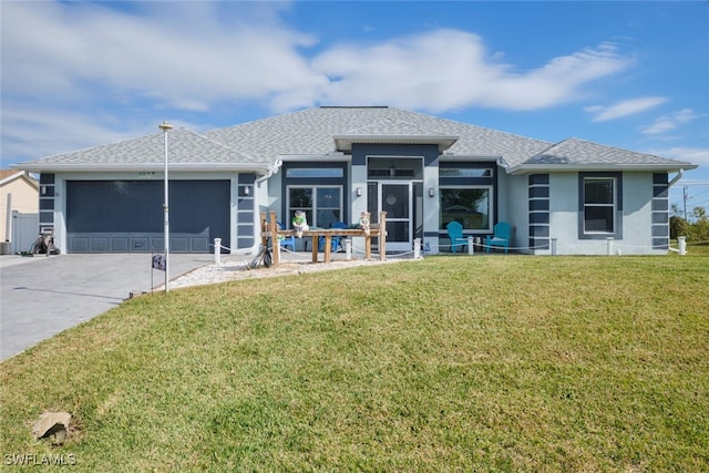 view of front of home with a garage and a front lawn