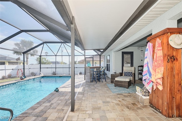 view of swimming pool with a lanai, exterior bar, and a patio