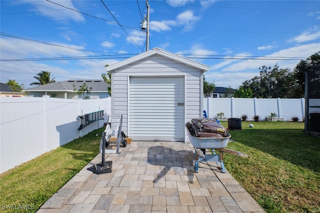 view of outdoor structure featuring a lawn