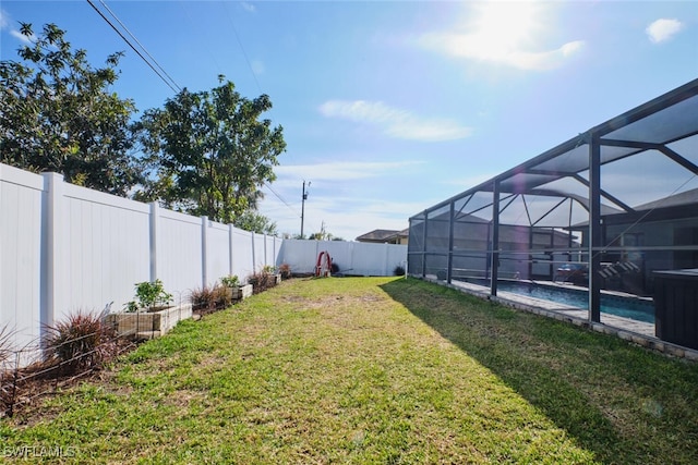 view of yard featuring a lanai and a fenced in pool