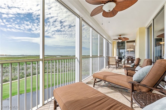 sunroom featuring ceiling fan