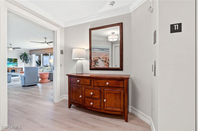 corridor featuring crown molding and light wood-type flooring