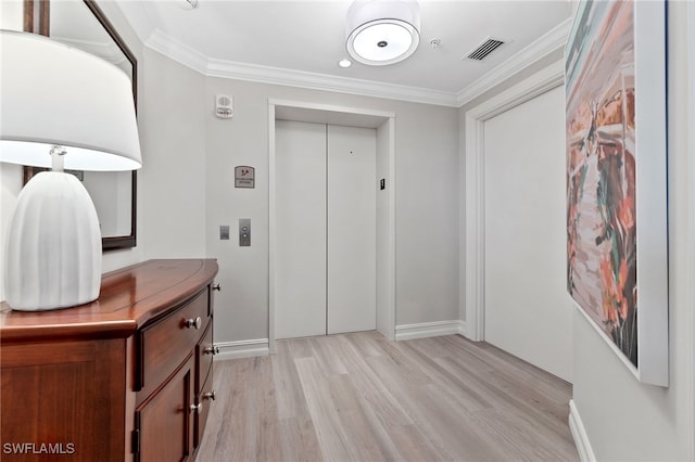 bathroom with vanity, crown molding, elevator, and hardwood / wood-style flooring