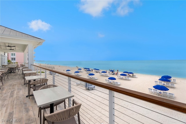 balcony with a view of the beach and a water view