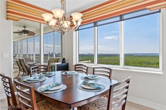 dining space featuring hardwood / wood-style floors and ceiling fan with notable chandelier