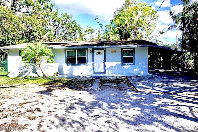 ranch-style home with a carport