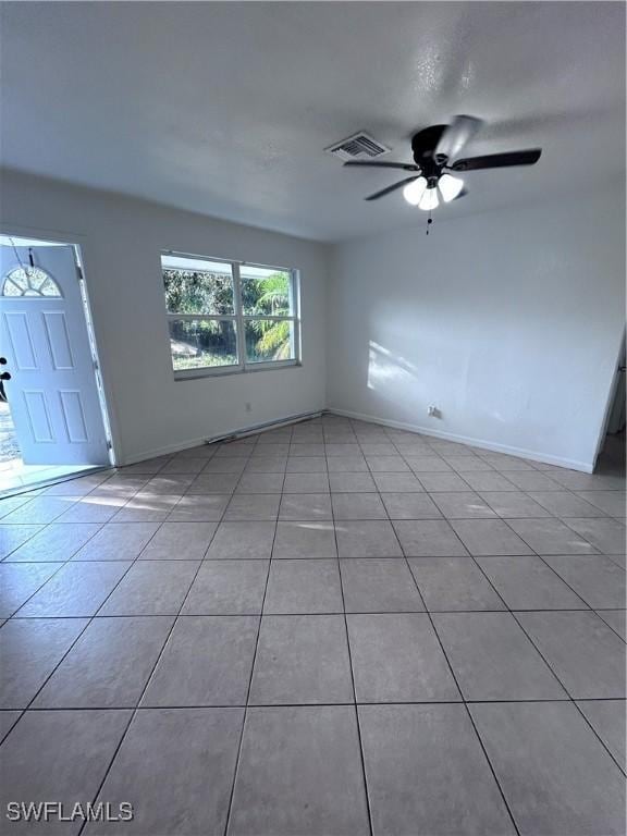 interior space with ceiling fan