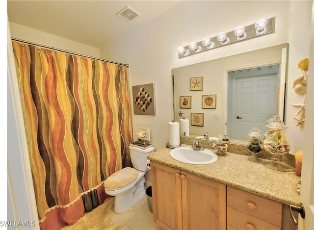 bathroom with tile patterned floors, vanity, and toilet