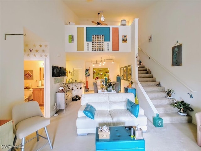 carpeted living room featuring ceiling fan