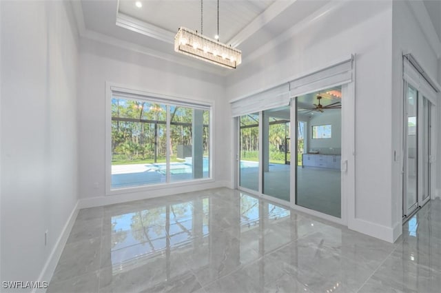 interior space with a tray ceiling and ceiling fan