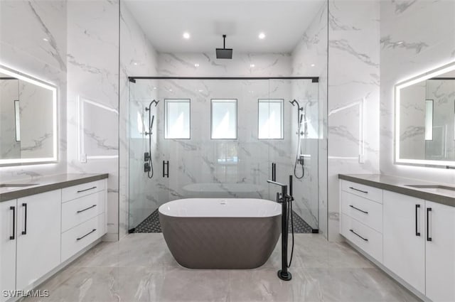 bathroom with vanity, tile walls, and independent shower and bath