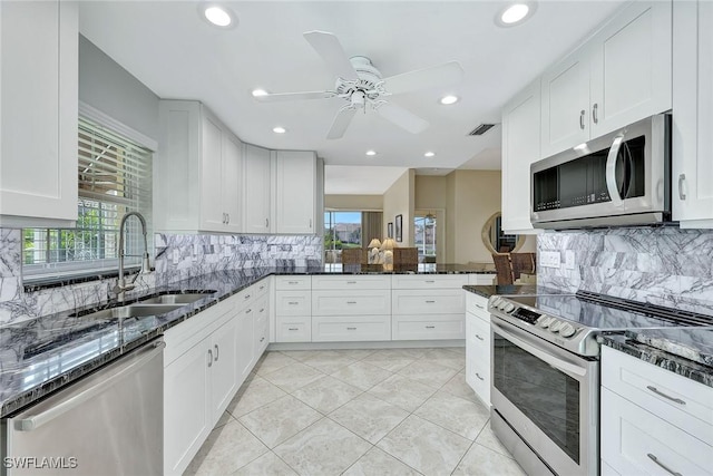 13120 Southampton Dr, Bonita Springs, FL 34135 - kitchen with a sink, a ceiling fan, appliances with stainless steel finishes, and dark stone countertops