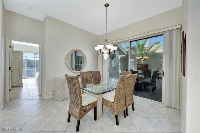 tiled dining room with a chandelier