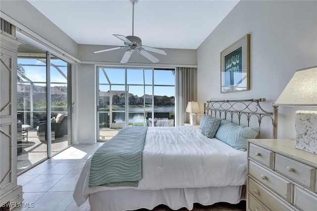 bedroom featuring ceiling fan, a water view, light tile patterned floors, and access to outside