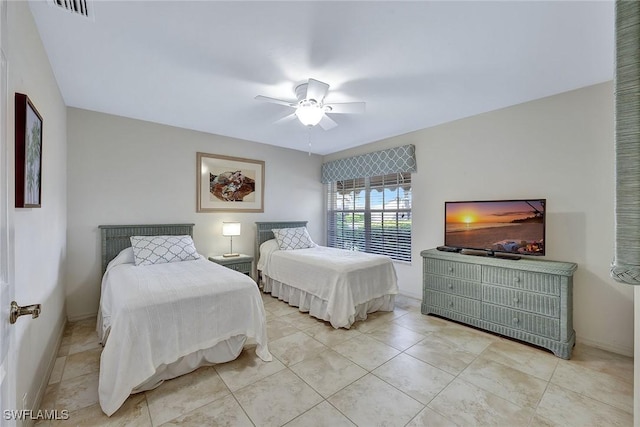 bedroom with ceiling fan and light tile patterned floors