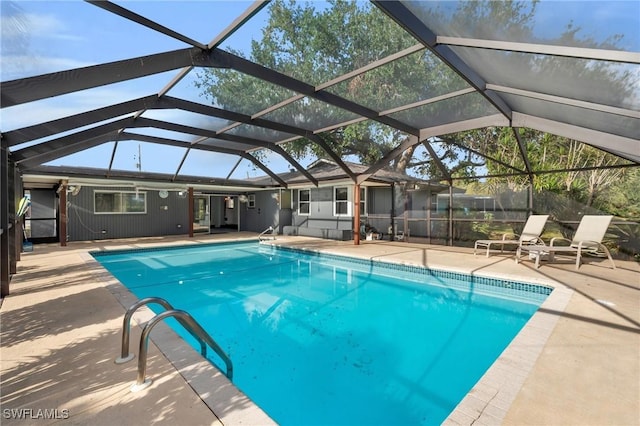 view of swimming pool featuring glass enclosure and a patio area