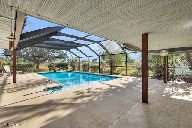 view of pool featuring glass enclosure and a patio area