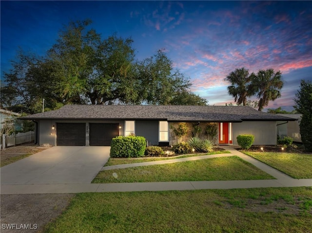 view of front of house featuring a garage and a yard