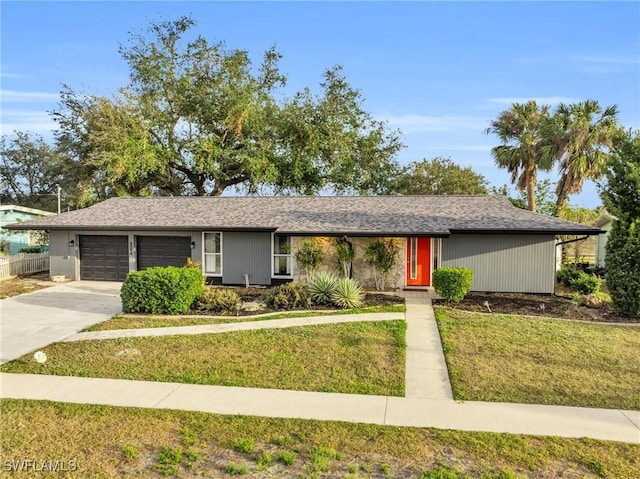 single story home featuring a garage and a front lawn