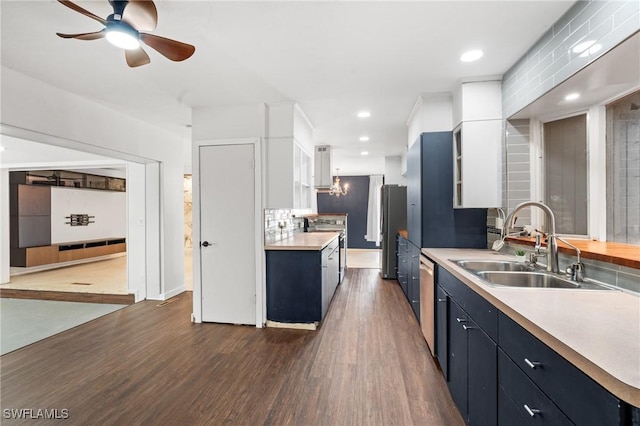 kitchen featuring dark hardwood / wood-style floors, white cabinetry, sink, and appliances with stainless steel finishes