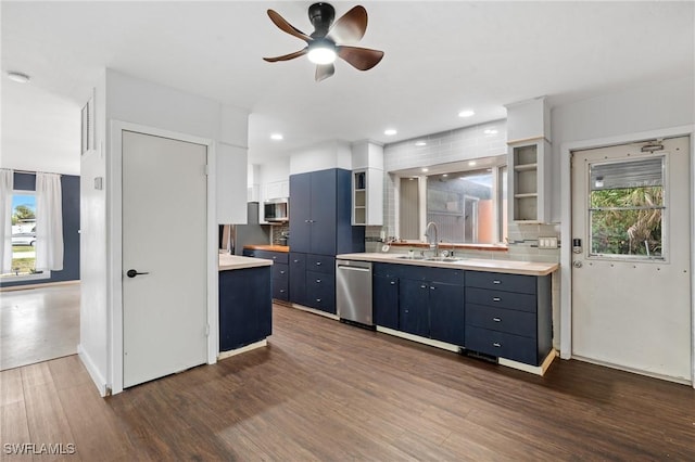 kitchen featuring backsplash, blue cabinets, sink, ceiling fan, and appliances with stainless steel finishes