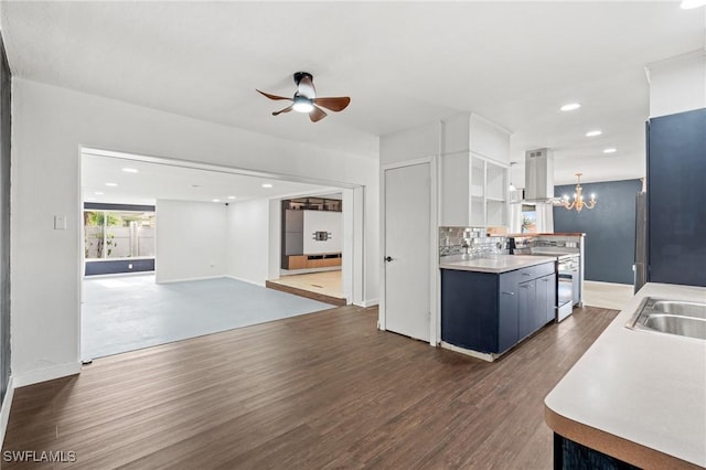 kitchen with backsplash, ceiling fan with notable chandelier, electric range, dark hardwood / wood-style floors, and white cabinetry