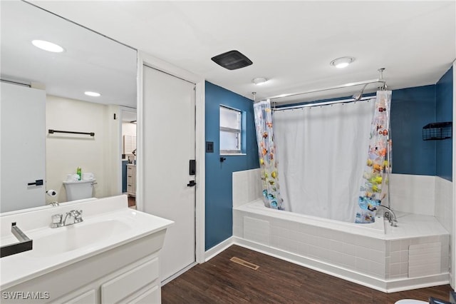 full bathroom with hardwood / wood-style floors, shower / bath combo, toilet, and vanity