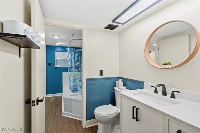 full bathroom with wood-type flooring, vanity, toilet, and shower / bath combination with curtain