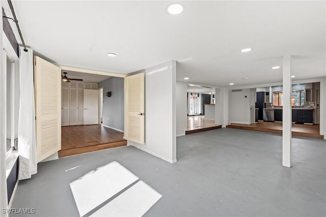 interior space with ceiling fan and concrete flooring