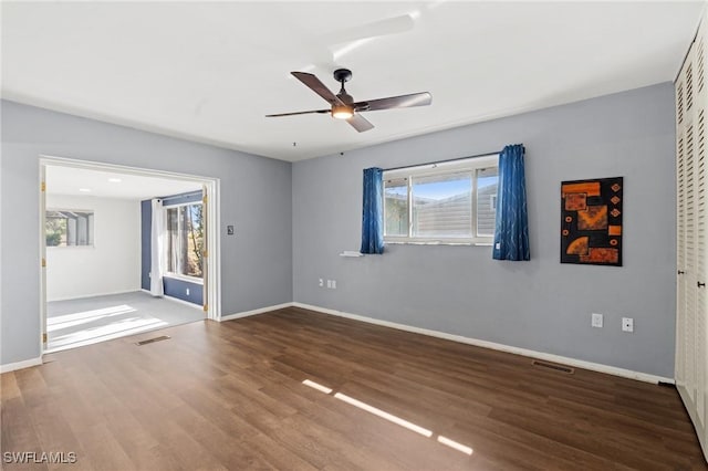 empty room featuring hardwood / wood-style flooring and ceiling fan