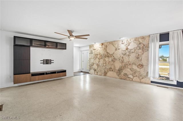 unfurnished living room with ceiling fan