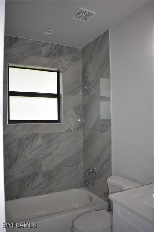 full bathroom featuring vanity, toilet, and tiled shower / bath