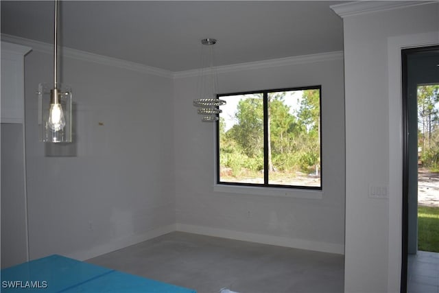 unfurnished dining area with crown molding and concrete floors