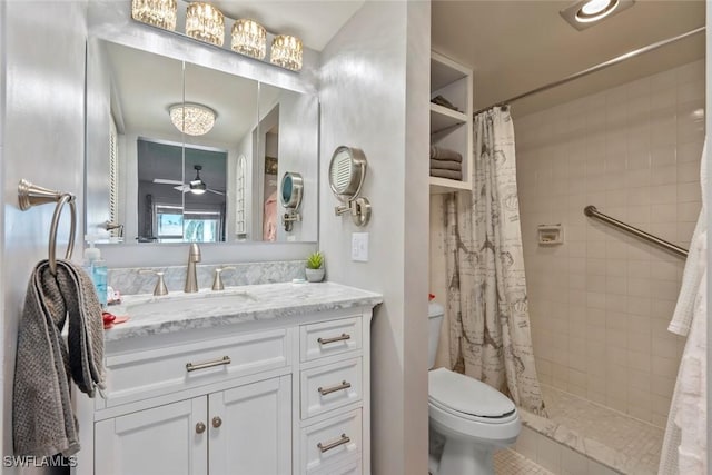 bathroom featuring toilet, vanity, ceiling fan, and walk in shower