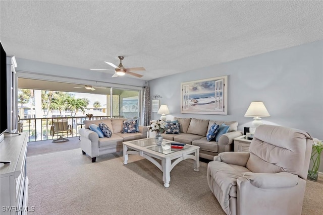 carpeted living room with a textured ceiling, ceiling fan, and a wealth of natural light